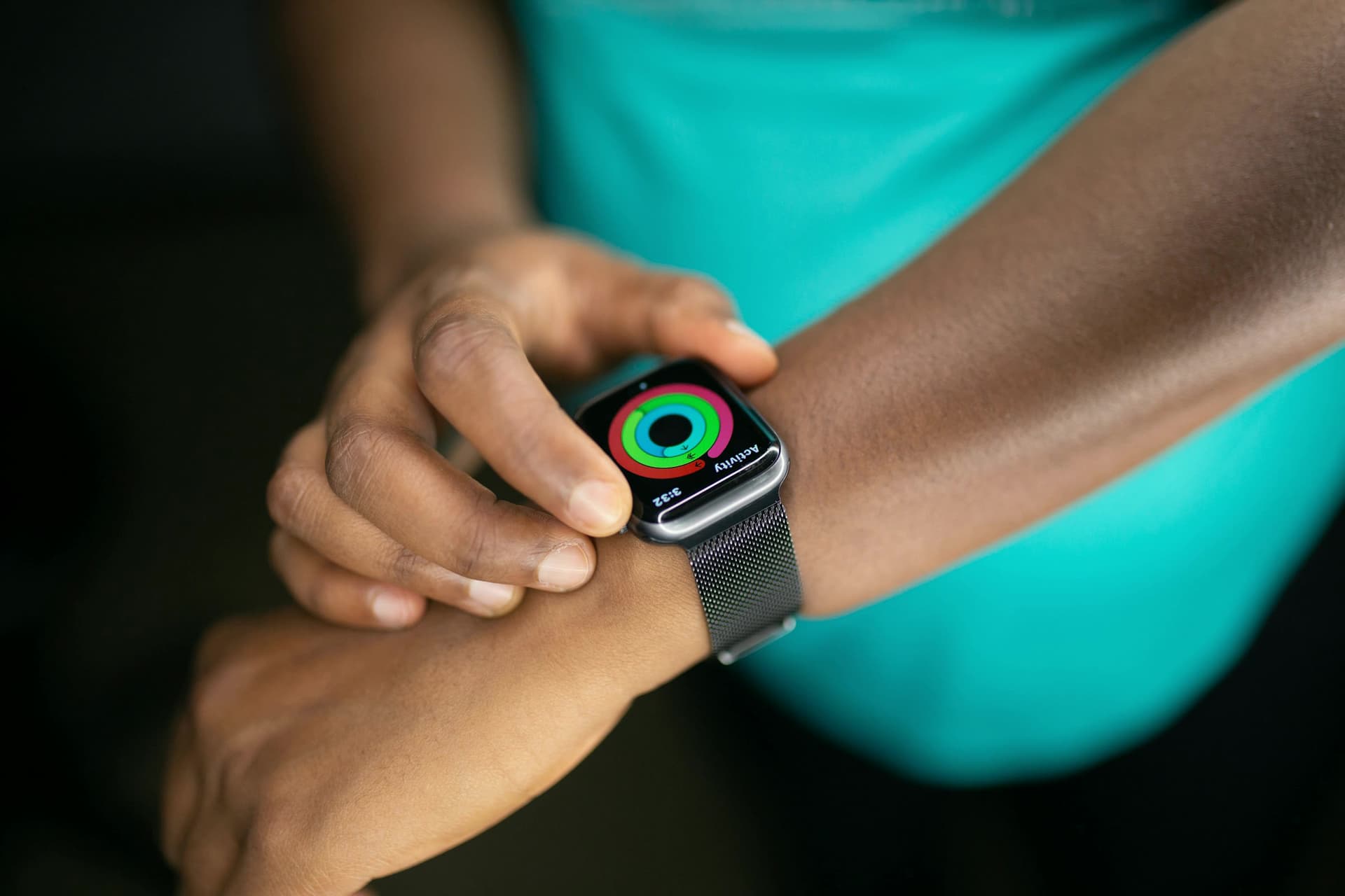 Someone tapping an activity ring on a smartwatch.